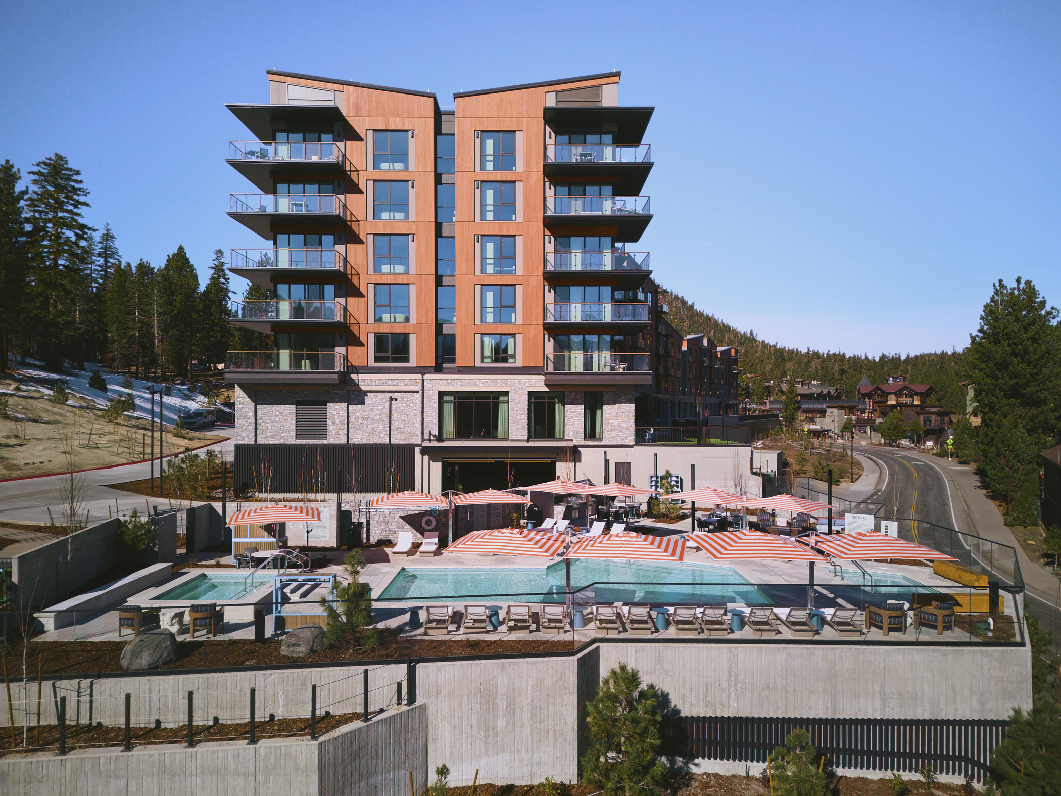 Limelight Mammoth, with its outdoor pool, hot tubs, and lounge deck below the guest tower