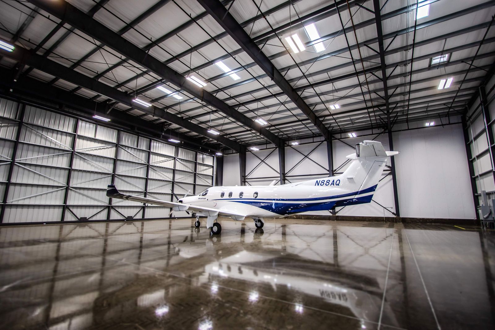 Right side profile of Pilatus PC-12 NG N88AQ with dark blue accent striping