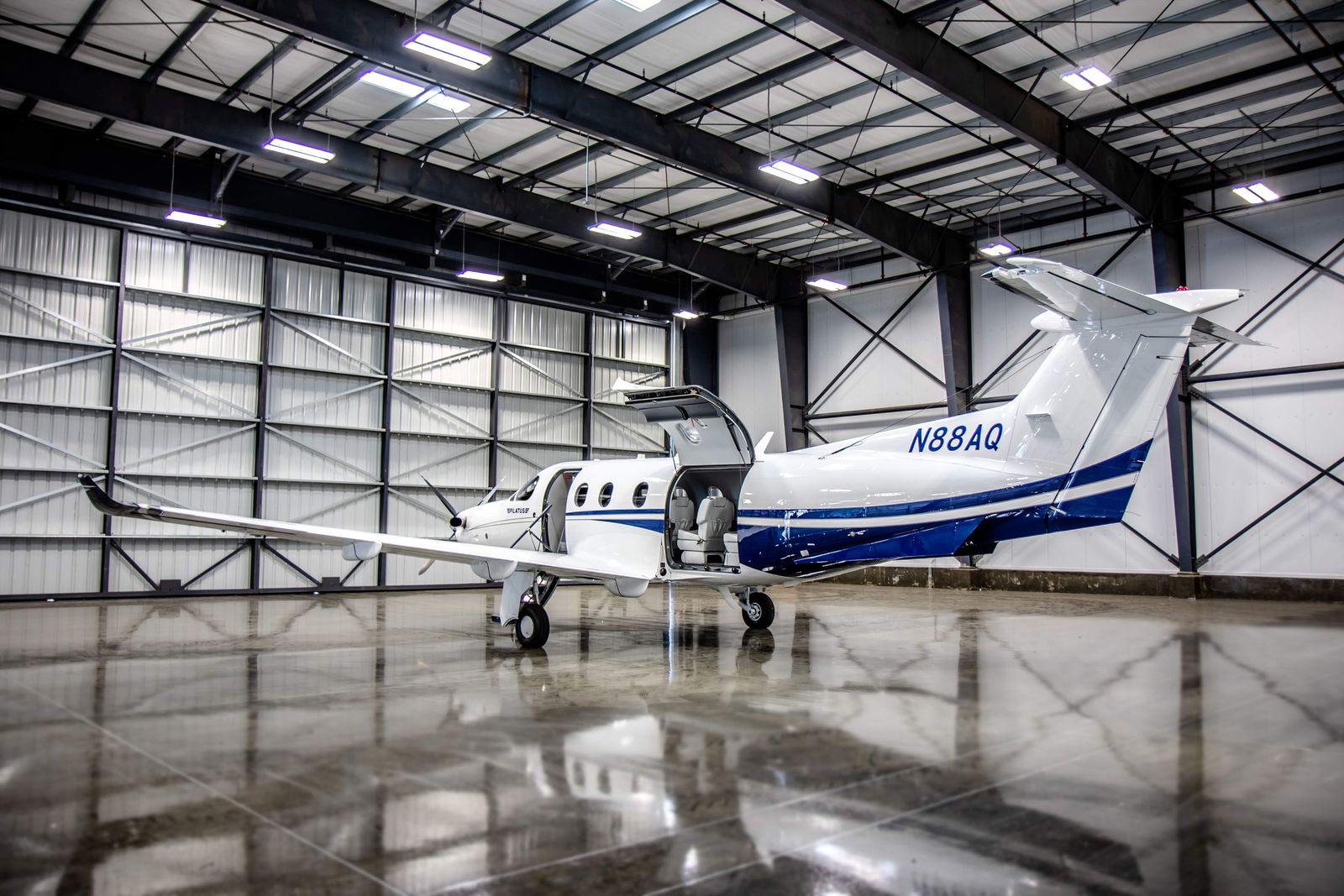 Rear three quarter view of N88AQ showing the open airstair and aft cargo door