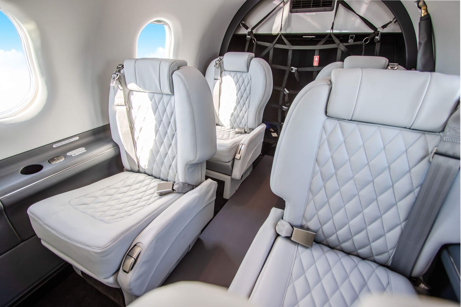 Diamond stitched light gray leather seats in the PC-12 NG cabin